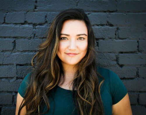 close up photography of a woman near wall