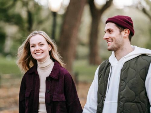smiling couple walking in park